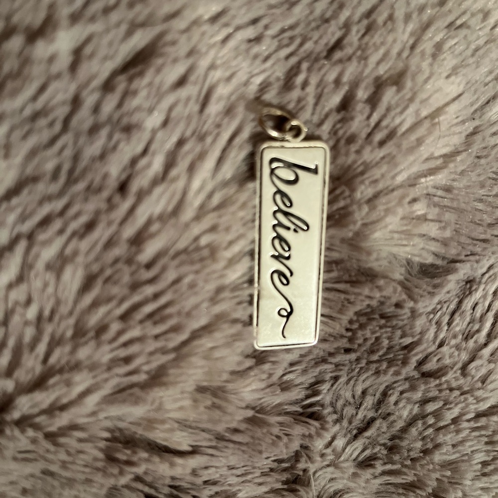 ‘Believe’ on one side, ‘Be patient, Be gentle, Be humble, Be loving’ charm
